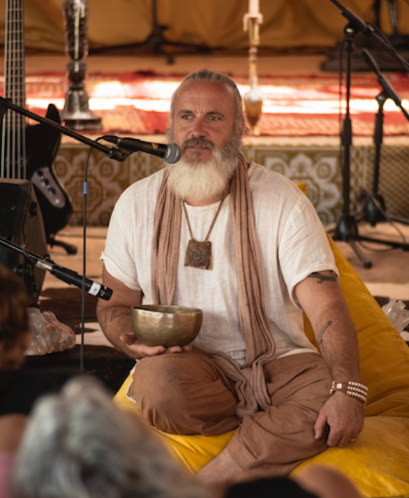 Hymnj, facilitator, holding a singing bowl during ceremony